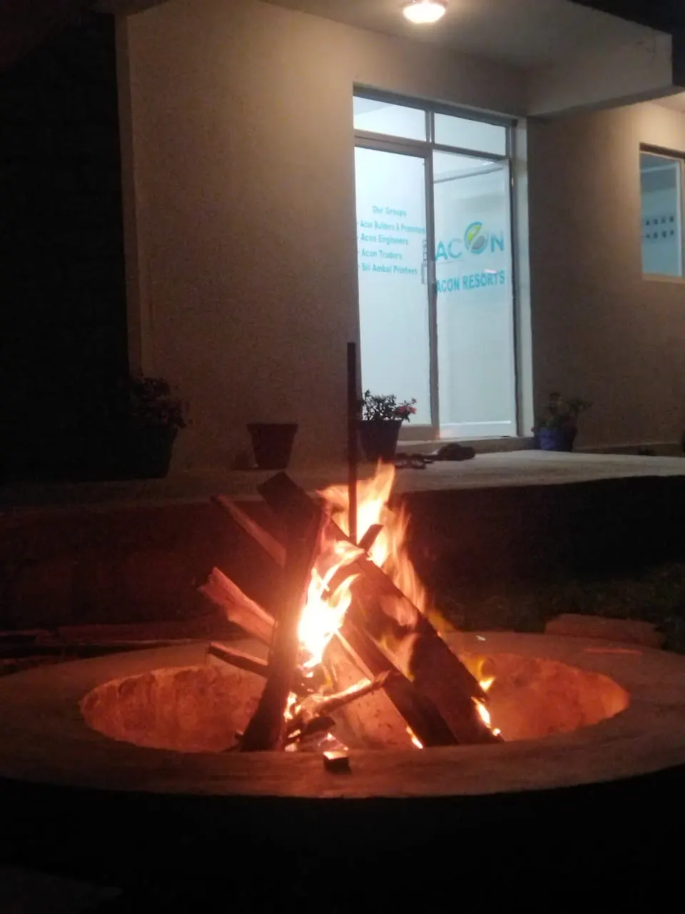 Evening campfire on a Kodaikanal resort lawn