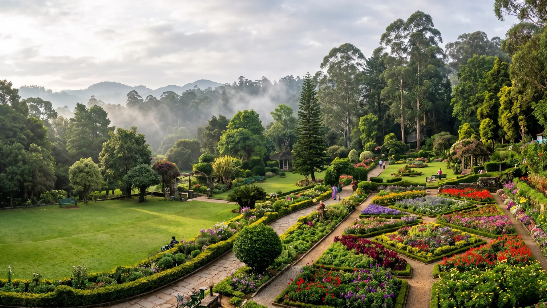 Flower beds and lawns in a Kodaikanal park on a misty morning